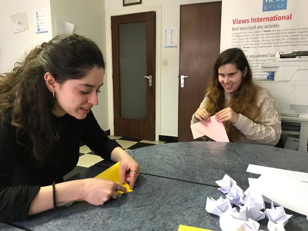 Beatrice and Jay create shapes from paper in the art of Origami
