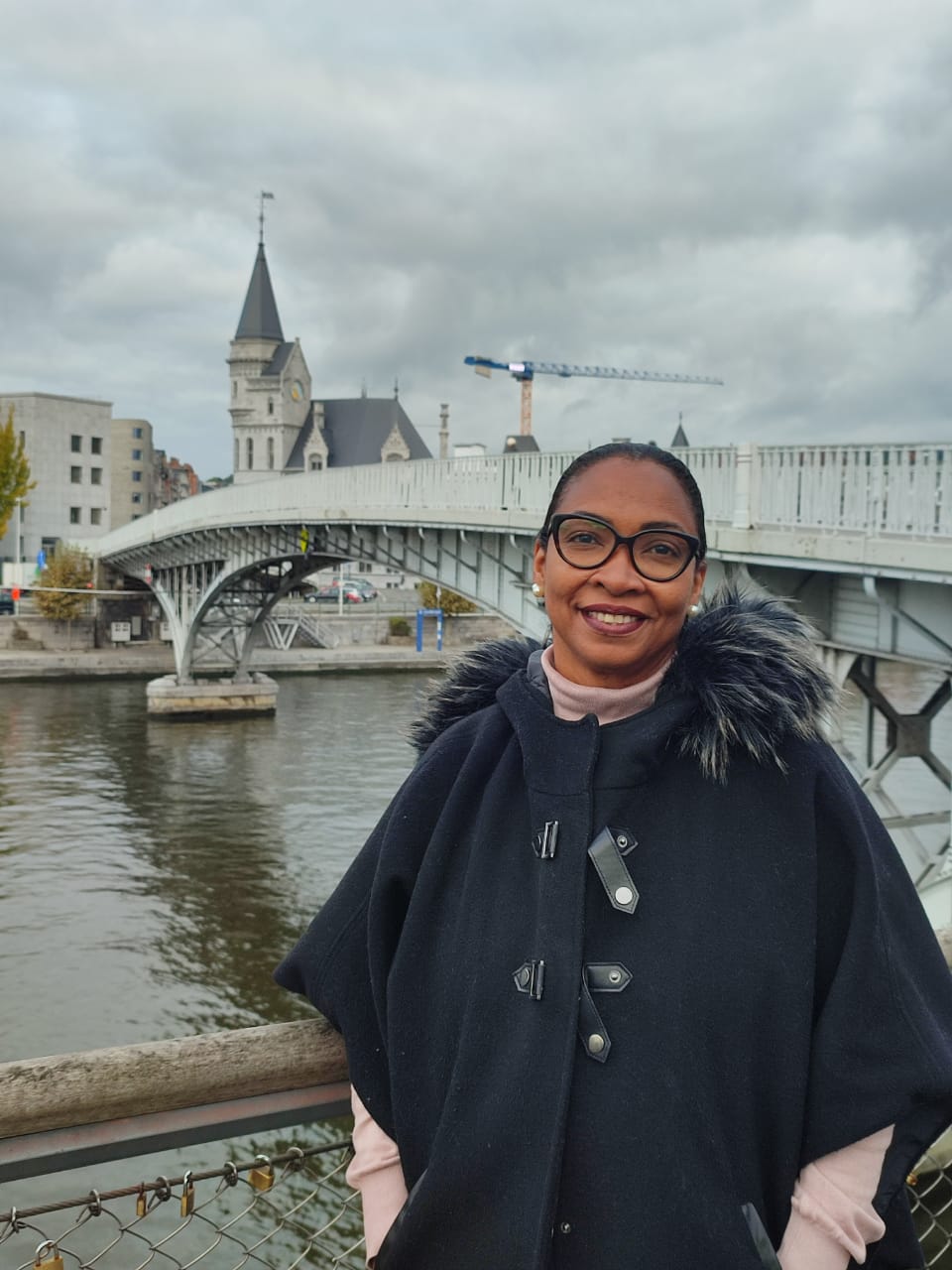 Marie-Claire Lavater posing for a picture in front of a bridge in Liège