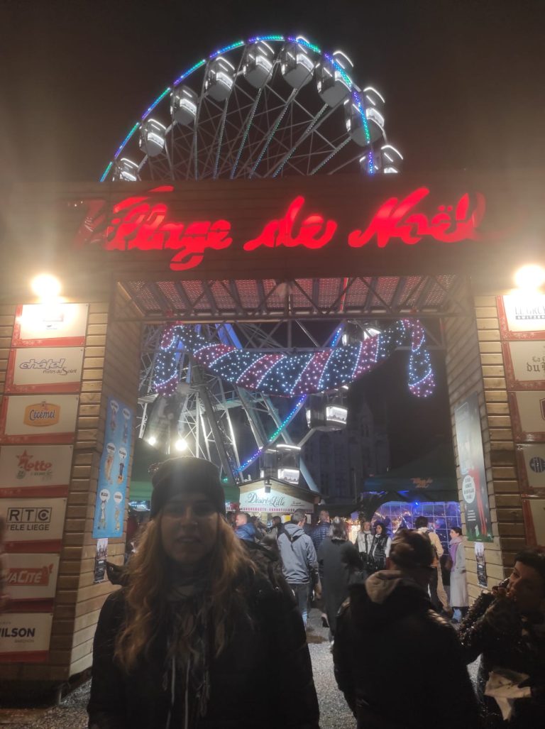 Patricia in front of a sign at the Marché de Noel