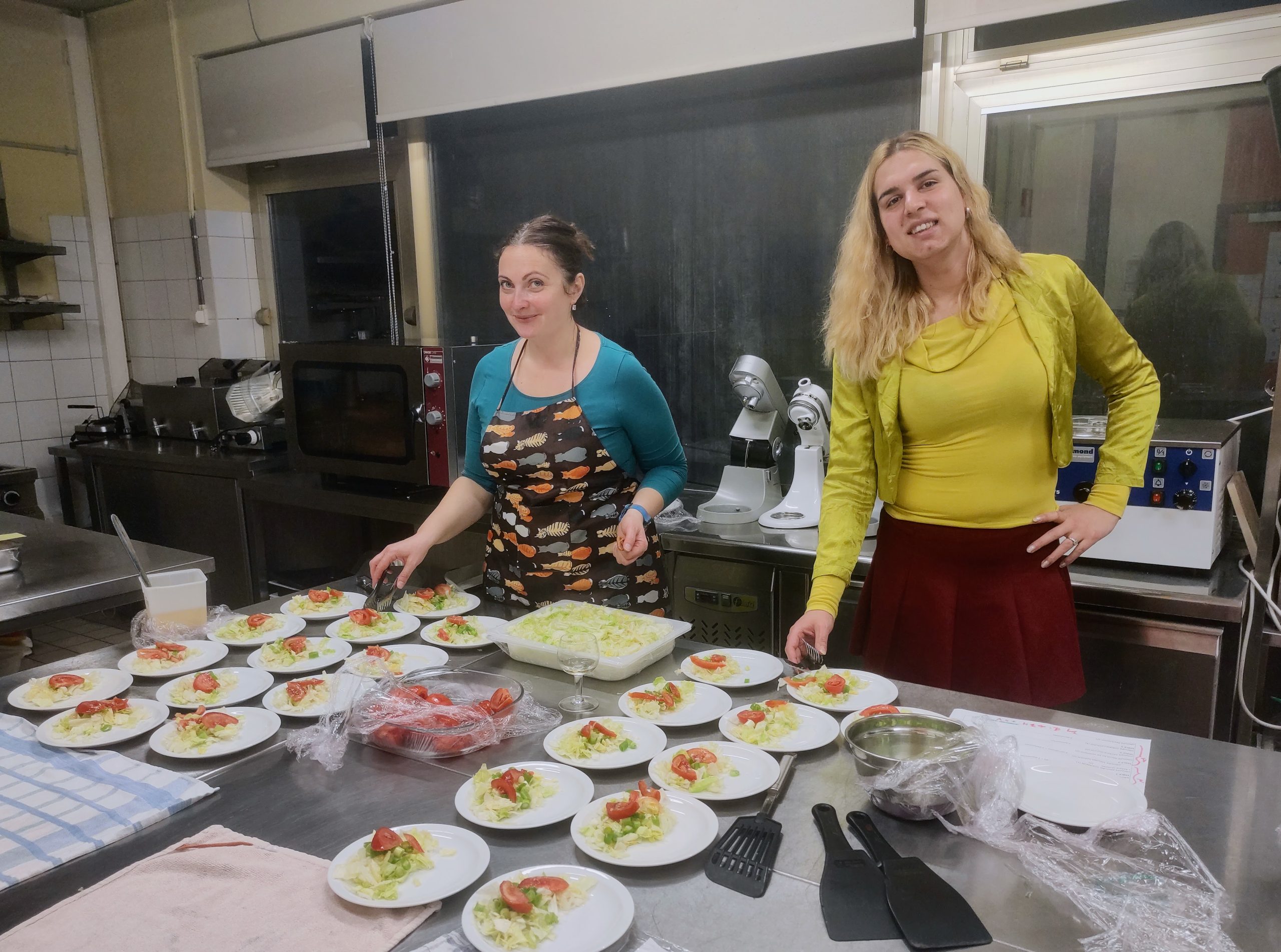Patricia with Anca setting up the dishes to serve at the Dinner in the Dark