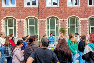 Organisations' fair - participants gathered around a stand as the Polish Association of the Blind present their activities