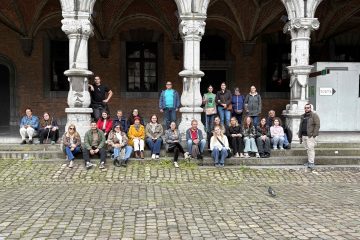 Group picture of the ACT-YOU participants in a square in Liège