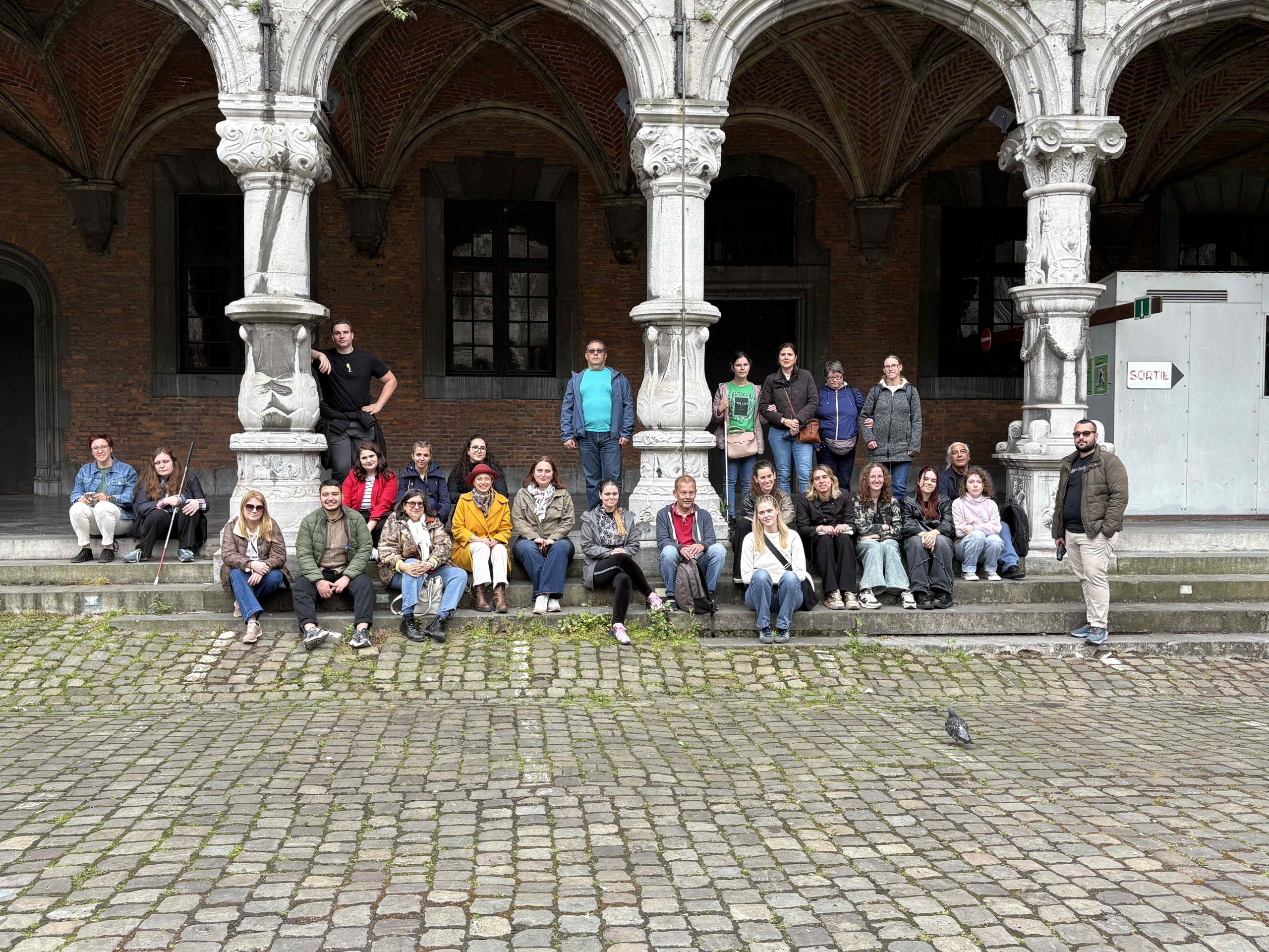 Group picture of the ACT-YOU participants in a square in Liège