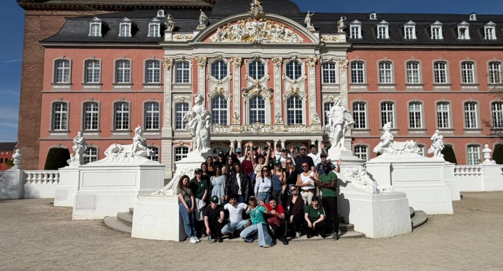 Participants' group posing in front of a nice building in Trier