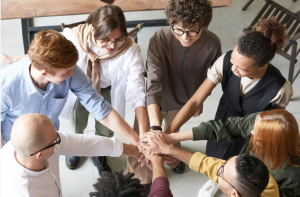 Team of people crossing hands