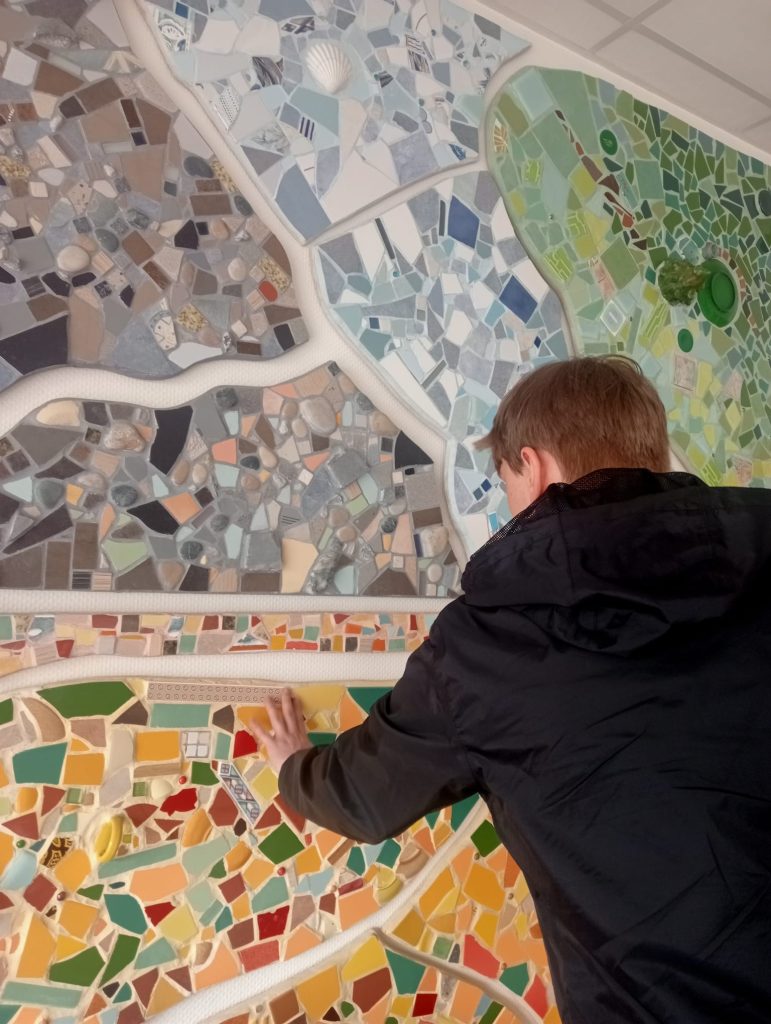 Jasper exploring a tactile mural at La Lumière