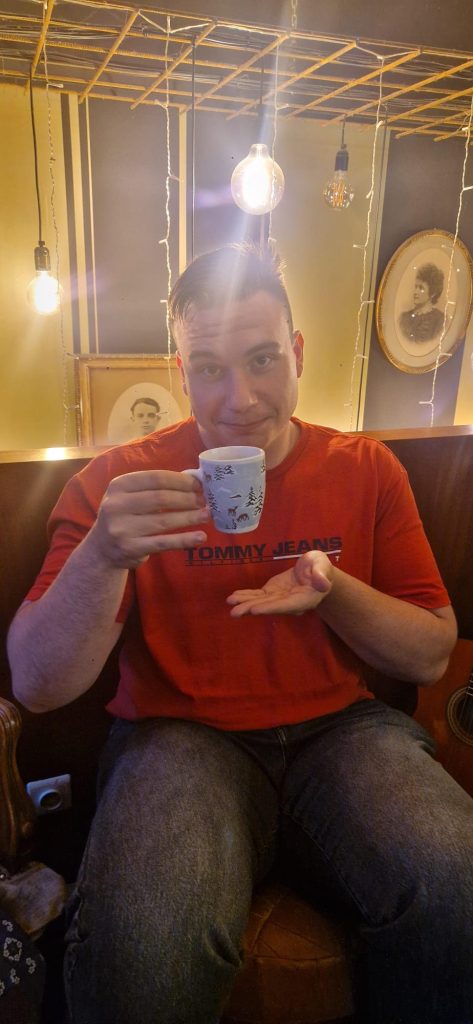 Picture of Silviu holding a tiny cup