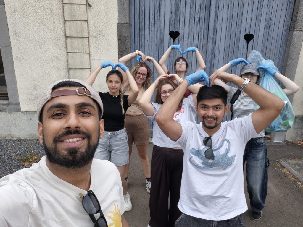 Cleaning activity: participants posing for a picture with blue gloves