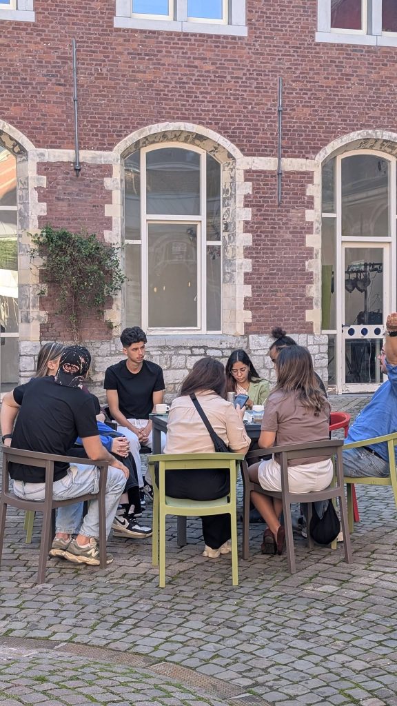 Small group of participants working on their project in the hostel's courtyard