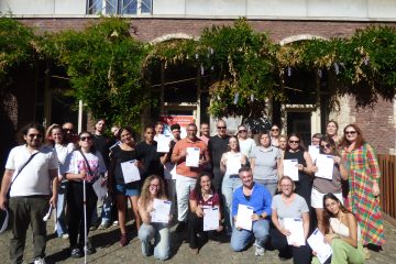 Participants in a group picture holding their youthpass