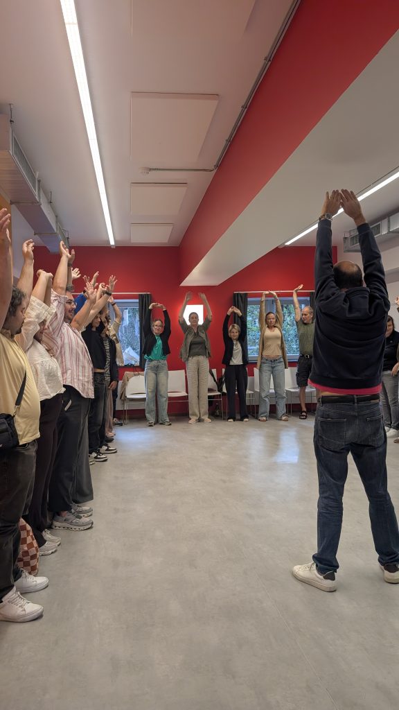 participants with their hands up during a warm-up activity